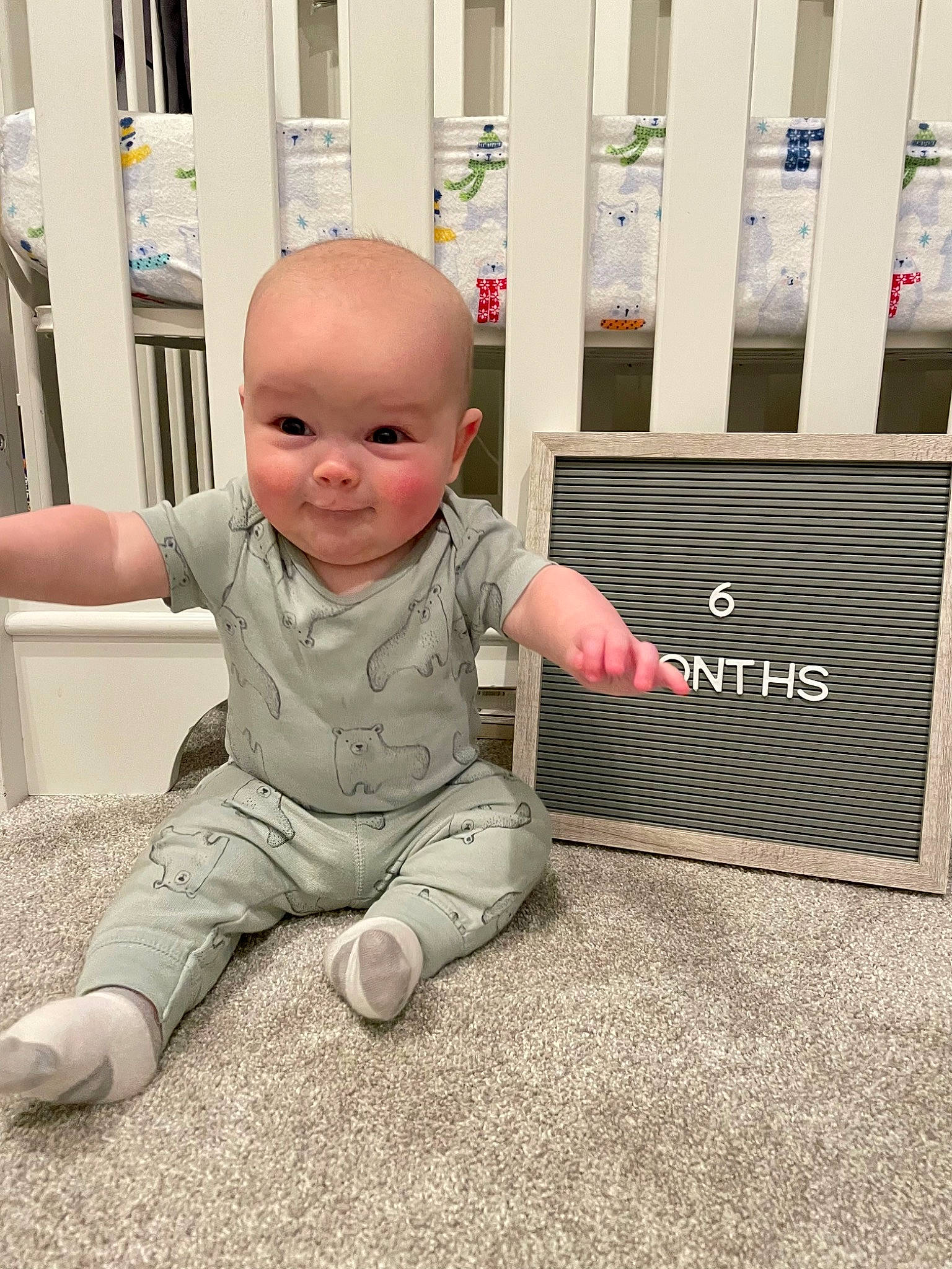 Owen is registered to the contest to win money with this photo: baby, baby_toddler_clothing, carpet, cheek, child, comfort, floor, flooring, foot, fun, grass, happy, person, product, room, sitting, sleeve, smile, t_shirt, toddler