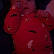 Kody joined the competition — help win amazing prizes! baby, infant, child, halloween, orange_clothing, onesie, pacifier, lying_down, cute, face, hand, dark_background, indoor, soft_toy, expression, portrait, newborn, sleepwear, bat_pattern, ghost_pattern
