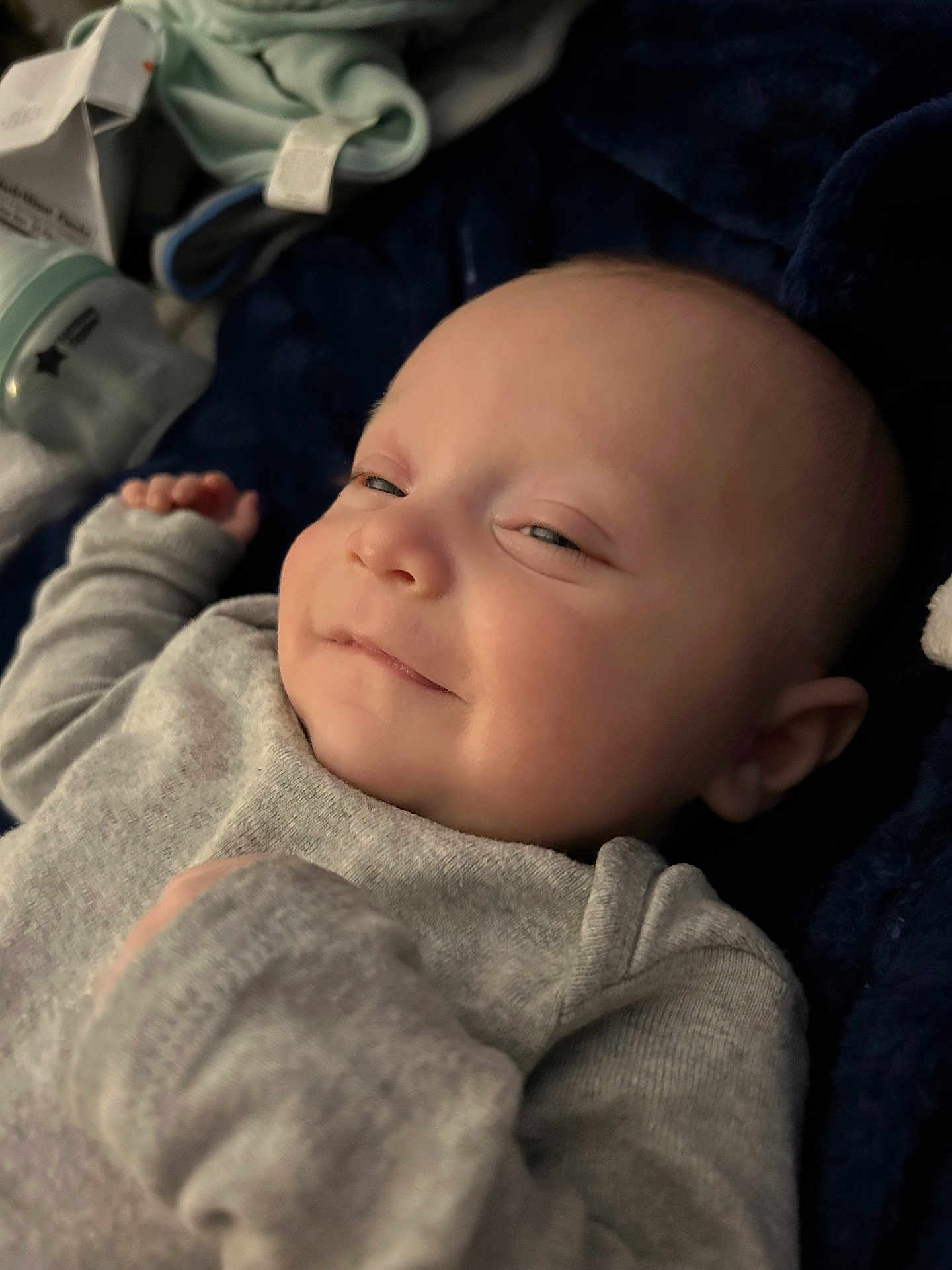 Kody joined the competition — help win amazing prizes! baby, infant, smiling, face, clothing, pajamas, blanket, bottle, lying_down, cozy, cute, skin, head, hand, expression, closeup, child, indoors, sleepwear, resting