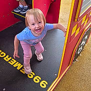 Hollie joined the competition — help win amazing prizes! child, toddler, smiling, playground, play_structure, outdoor, playground_equipment, climbing, stairs, colorful, pink_clothing, blue_shirt, sneakers, blond_hair, happy, portrait, standing, recreation, carpeted_surface, family