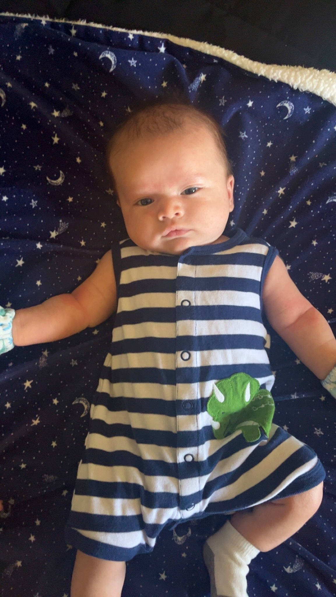 Julian is registered to the contest to win money with this photo: azure, baby, baby_toddler_clothing, cheek, child, cool, eye, facial_expression, finger, gesture, hairstyle, head, human, iris, nose, organ, person, skin, sleeve, standing
