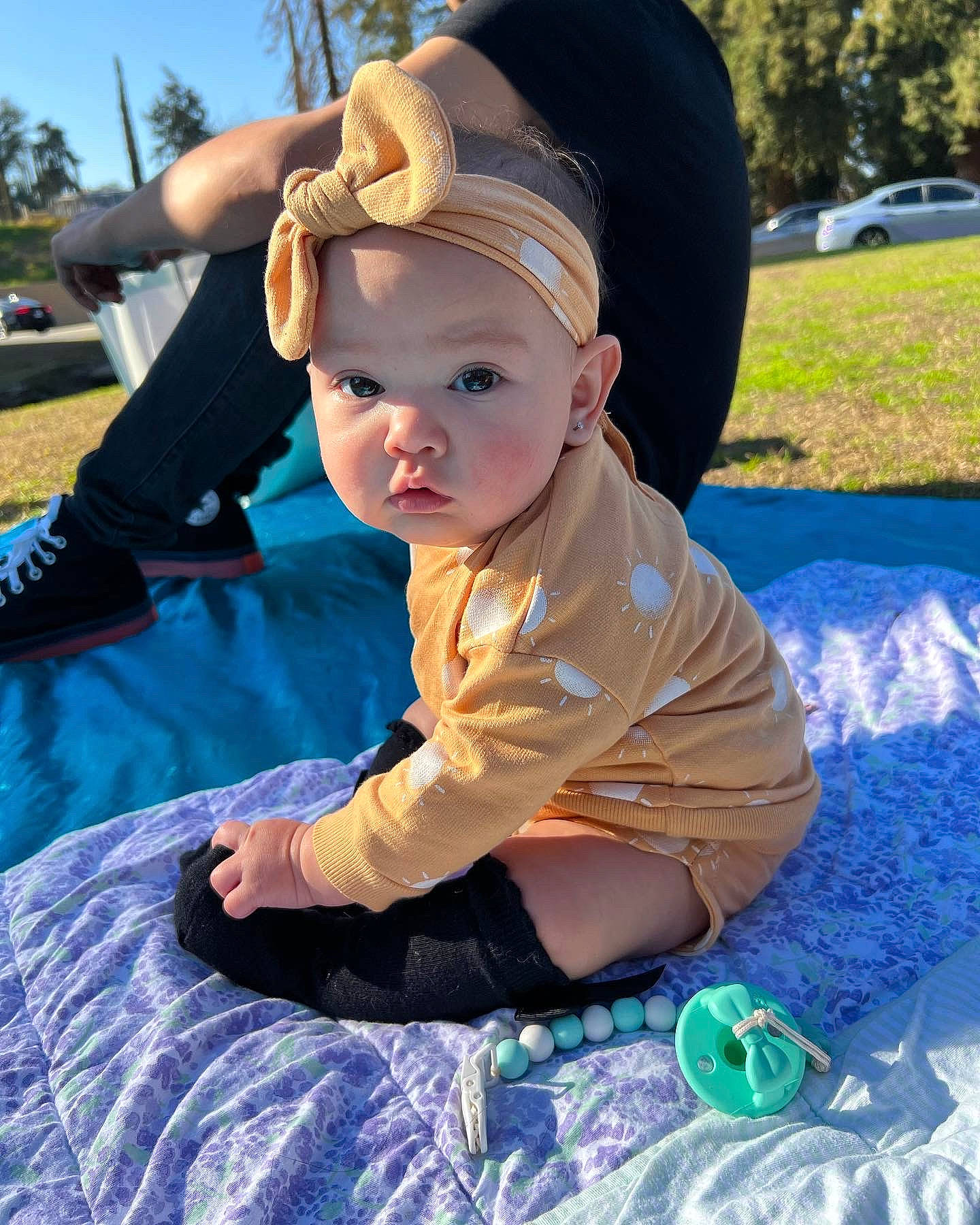 Juliet is registered to the contest to win money with this photo: baby, baby_toddler_clothing, baseball_cap, cap, child, costume_hat, electric_blue, fashion_accessory, fun, grass, happy, hat, headwear, leisure, person, plant, recreation, sitting, sky, sun_hat