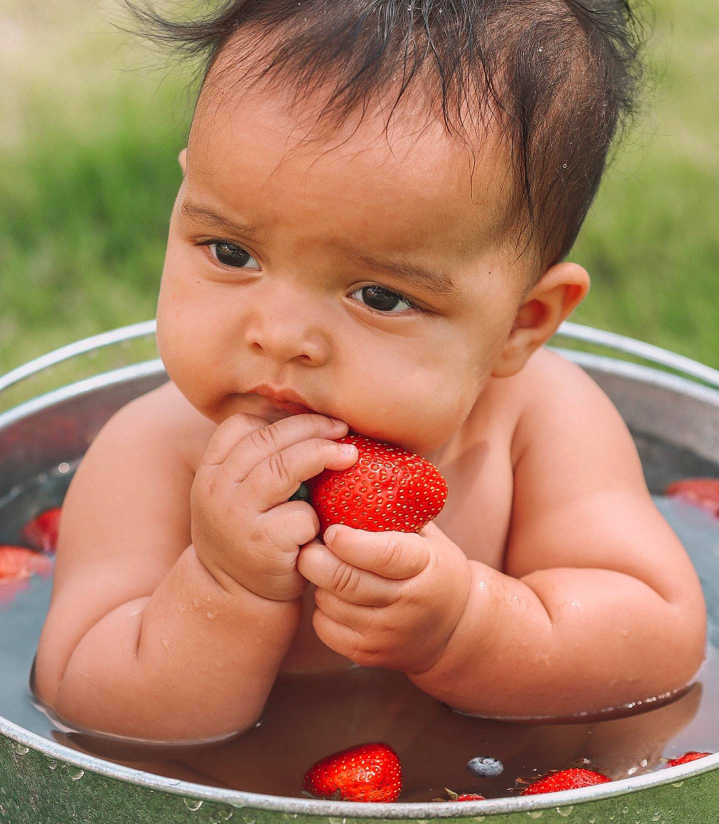 Lila is registered to the contest to win money with this photo: arm, baby, chest, finger, fruit, gesture, hand, happy, human_body, leisure, lip, muscle, nail, natural_foods, person, red, skin, strawberry, thumb, toddler