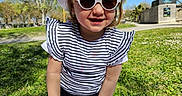 Avaluna participe au concours pour gagner de l'argent avec cette photo : child, girl, sunglasses, hat, smartphone, outdoor, grass, blue_sky, sunny, striped_shirt, blanket, park, casual_clothing, smiling, daylight, person, nature, young_child, fashion, playful