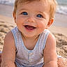 baby, child, smiling, blue_eyes, sand, beach, sitting, happy, cute, arms, tank_top, summer, outdoor, portrait, person, sunlight, blond_hair, nature, playful, vacation