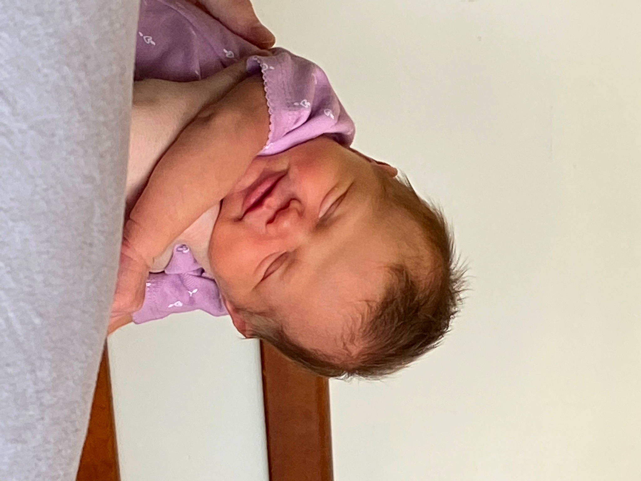 Elizabeth is registered to the contest to win money with this photo: arm, baby, baby_toddler_clothing, cheek, chest, child, comfort, elbow, eyelash, fashion_accessory, happy, human_body, linens, magenta, neck, nose, pattern, person, sleeve, smile