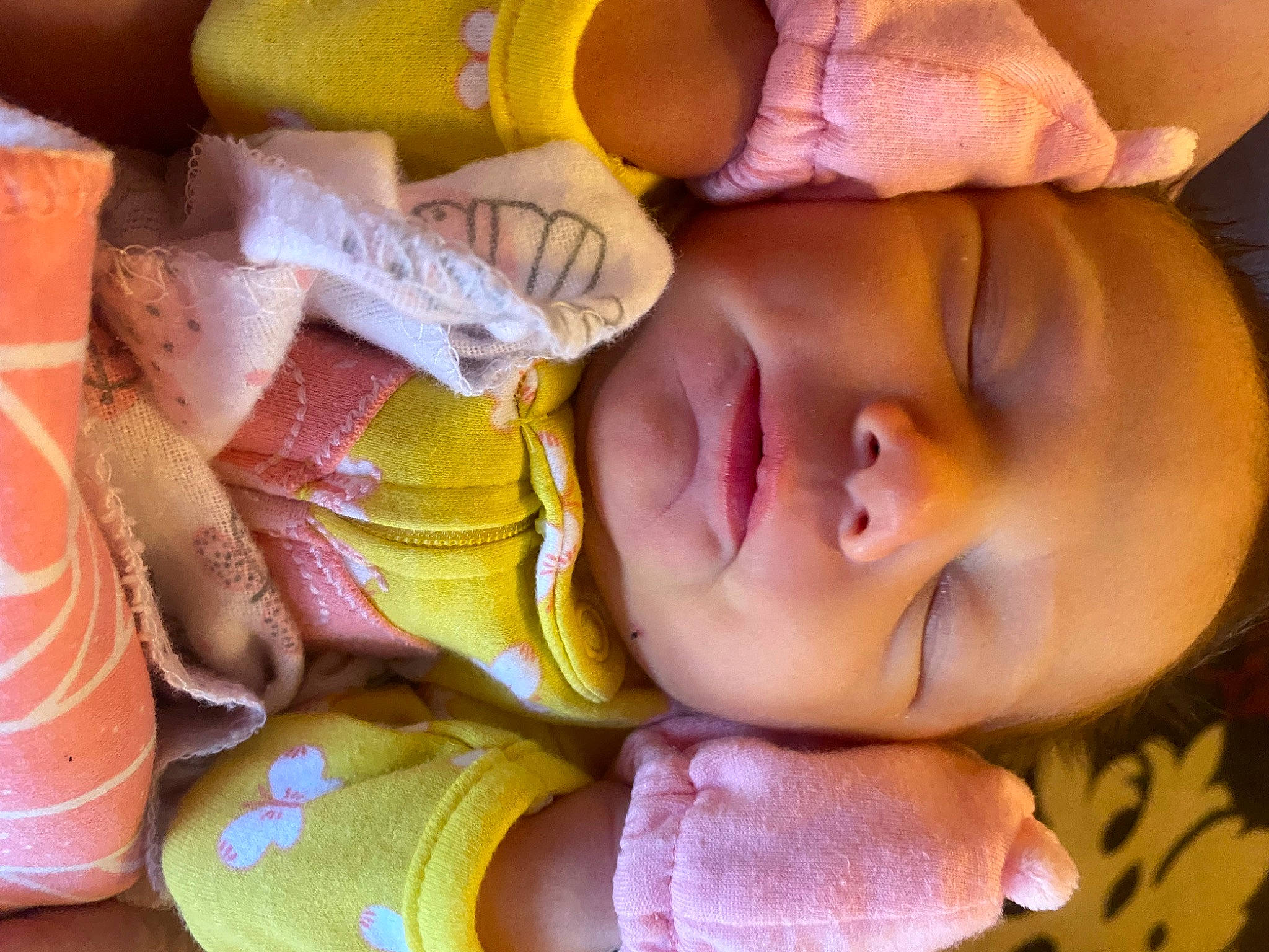 Elizabeth is registered to the contest to win money with this photo: arm, baby, baby_toddler_clothing, cheek, eye, facial_expression, finger, hand, human_body, iris, leg, lip, mouth, muscle, nose, orange, organ, person, product, skin