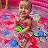baby, blue, child, colorful, cute, fun, happy, inflatable_pool, necklace, outdoor, pink, playful, red, sleeveless, smiling, splash, summer, tongue_out, water, water_balloons