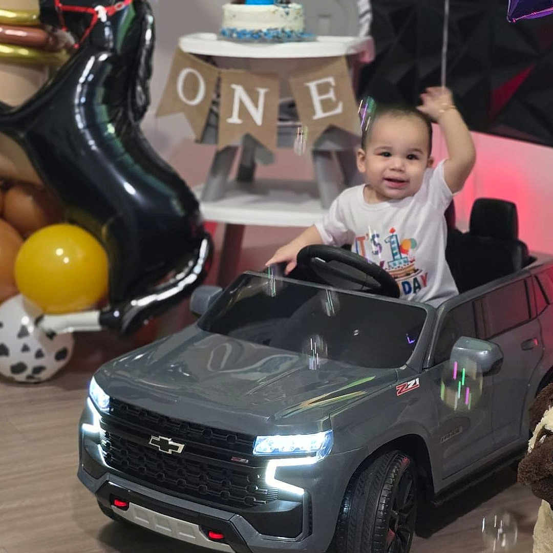 Juseph joined the competition — help win amazing prizes! toddler, birthday, toy_car, balloons, cake, celebration, indoor, child, smiling, happy, first_birthday, plush_toy, decorations, party, chevrolet, floor, table, colorful, lights, cute