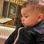 Jad a rejoint le concours — aidez-le/la à gagner de superbes lots ! child, toddler, baby, profile, birthday_banner, party, jacket, coat, indoor, restaurant, dining_table, chairs, celebration, portrait, pensive, cheeks, hair, close_up, person, festive