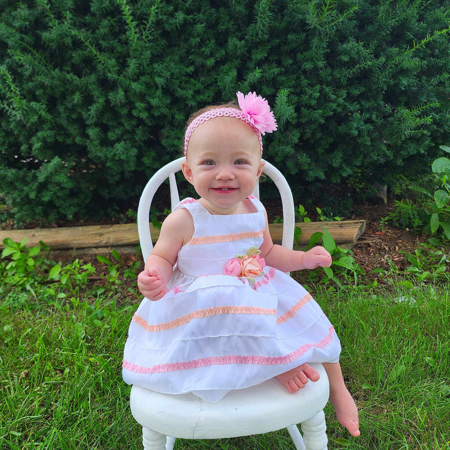 Winifred is registered to the contest to win money with this photo: baby, backyard, chair, clothing, dress, face, furniture, grass, head, lawn, nature, outdoors, person, photography, plant, portrait, sitting, tree, vegetation, yard