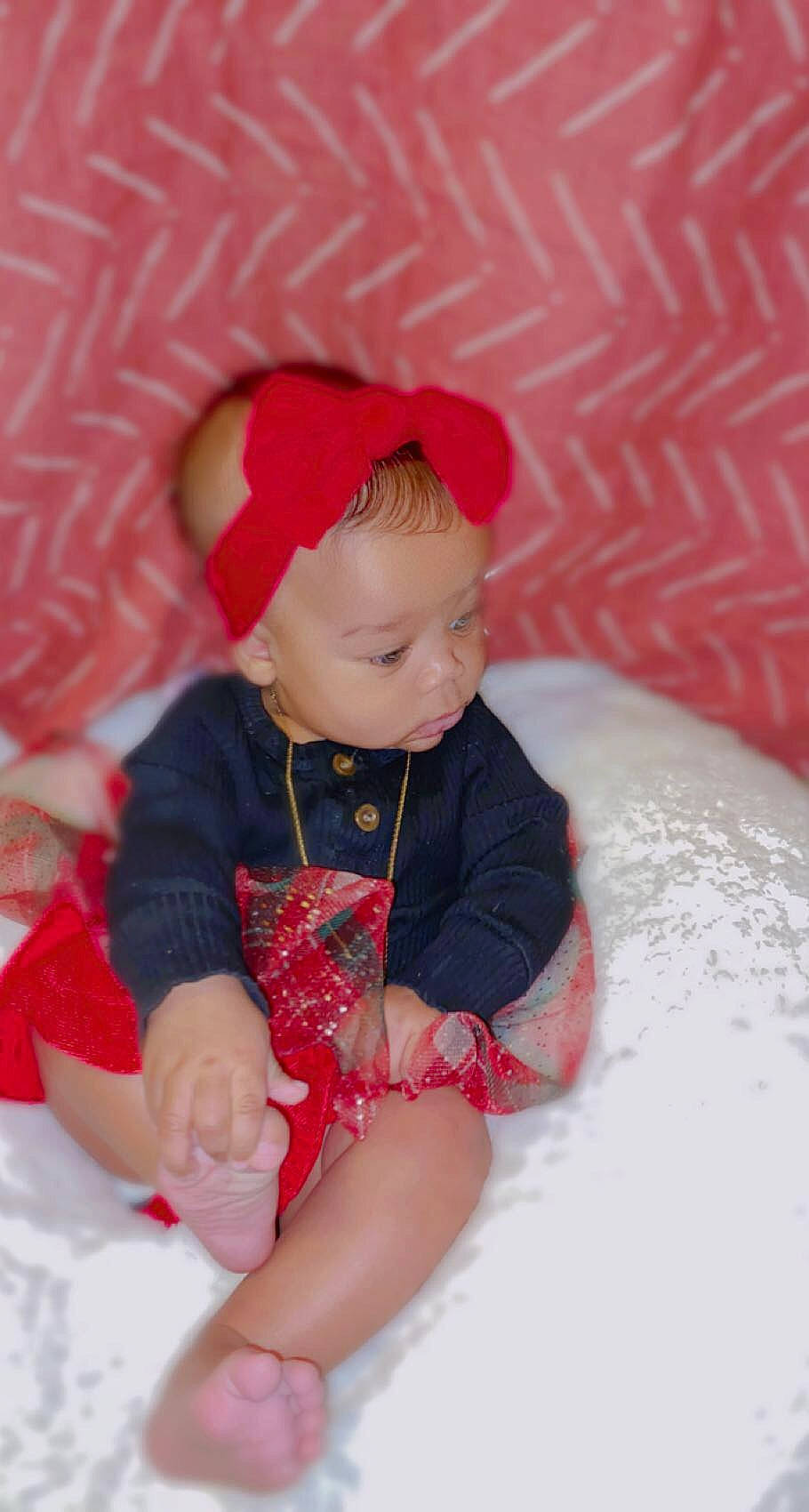 Avayah is registered to the contest to win money with this photo: baby, baby_toddler_clothing, carmine, child, comfort, costume, doll, figurine, head, headgear, human_leg, lap, leg, person, pink, sitting, skin, sleeve, sock, toddler