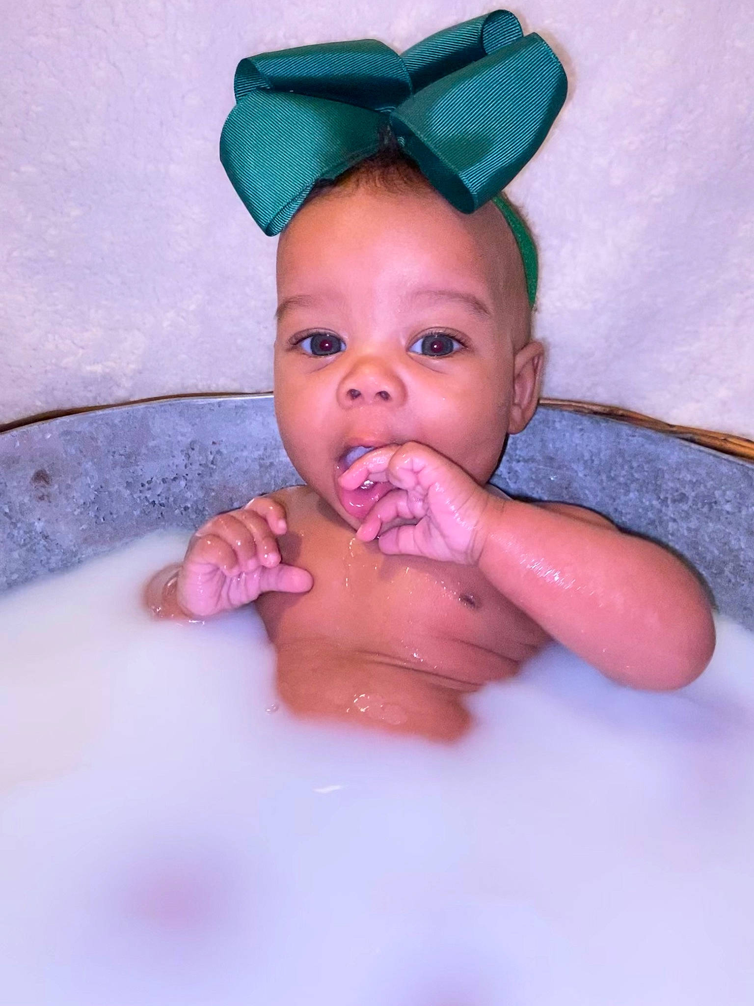 Avayah is registered to the contest to win money with this photo: baby, bathing, cap, child, eye, eyebrow, finger, gesture, happy, headgear, human_body, iris, lip, mouth, nose, person, pink, skin, stomach, thumb