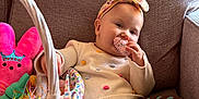 Allison joined the competition — help win amazing prizes! baby, child, couch, toy, basket, headband, polka_dot, sweater, chocolate_brown, pink, green, easter, indoor, cute, smiling, snack, holiday, relaxed, playful, infant