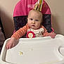 Allison is registered to the contest to win money with this photo: baby, birthday, high_chair, party_hat, messy, food, child, pink, celebration, face, hands, cute, indoor, polka_dot, clothing, person, seat, happy, toddler, snack