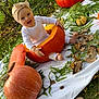 baby, pumpkin, autumn, leaf, fern, blanket, outdoor, grass, headband, smile, child, nature, fall, cute, white_clothing, feet, happy, seasonal, sitting, holiday