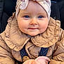 baby, child, blue_eyes, head_wrap, beige_jacket, quilted_clothing, car_seat, blanket, infant, cute, portrait, closeup, warm_clothing, happy, smiling, face, hands, soft_fabric, indoors, person