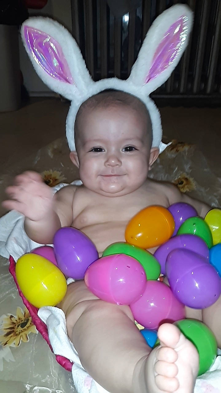 Amya is registered to the contest to win money with this photo: balloon, child, ear, easter, easter_bunny, easter_egg, holiday, joy, party_supply, person, toddler