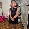 Delilah joined the competition — help win amazing prizes! child, girl, portrait, smiling, standing, dress, navy_dress, lace, sandals, purse, hair_bow, indoors, doorway, home, laundry_room, wood_floor, basket, closet, formalwear, fashion