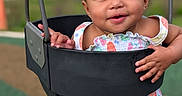 Alor'Sekani joined the competition — help win amazing prizes! baby, child, swing, playground, smiling, happy, portrait, outdoor, infant, sitting, playground_equipment, colorful_clothing, dress, shorts, earrings, face, eyes, hands, blurred_background, daylight