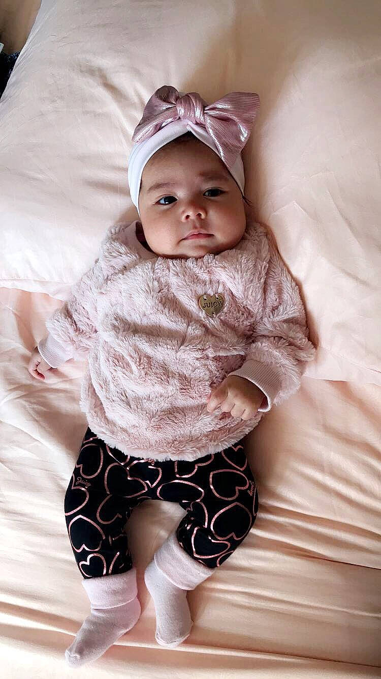 Alanah joined the competition — help win amazing prizes! baby, baby_products, baby_toddler_clothing, beauty, child, child_model, eye, fashion_accessory, head, headgear, pattern, person, photography, pink, product, skin, sleeve, smile, textile, toddler