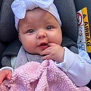 Valentina participe au concours pour gagner de l'argent avec cette photo : adorable, airbag_label, baby, bow, car_seat, cheeks, close_up, clothing, cozy, eyes, fingers, hand, harness, headband, infant, pink_blanket, portrait, seat, soft_texture, wide_eyed