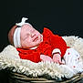 baby, sleeping, headband, red_clothing, basket, fluffy_blanket, infant, cute, peaceful, cozy, portrait, child, soft_texture, white, newborn, resting, indoor, warm, smiling, relaxed