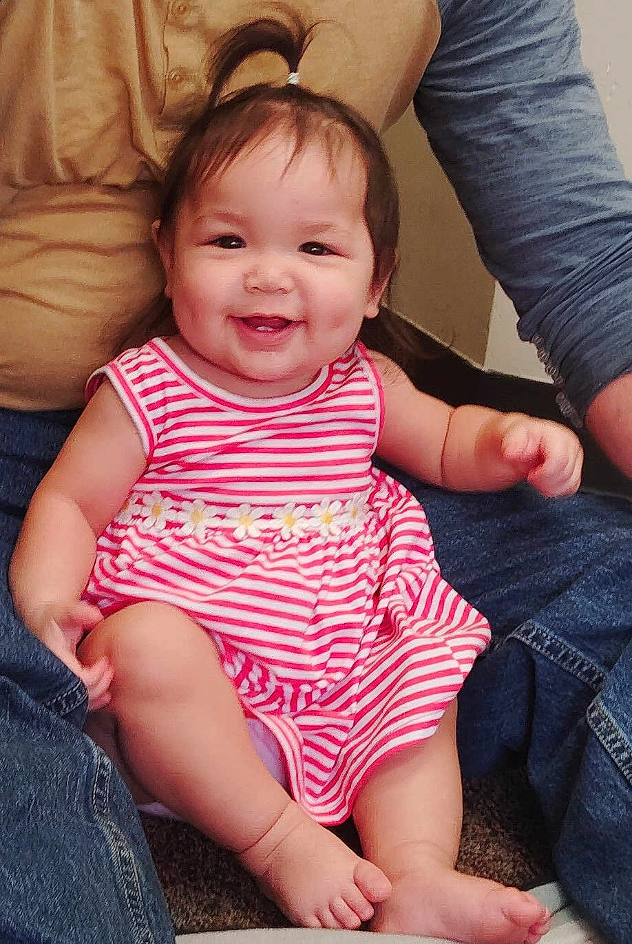 Avrianna is registered to the contest to win money with this photo: adult, baby, carpet, casual_clothing, child, cute, daisies, denim, family, feet, hair, hands, happy, indoor, legs, people, pony_tail, sitting, smiling, striped_dress