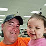 Avrianna joined the competition — help win amazing prizes! baby, cap, casual, closeup, dimples, face, happy, indoor, lighting, man, orange_shirt, parent_and_child, people, pink_shirt, portrait, retail, selfie, shelves, smiling, store