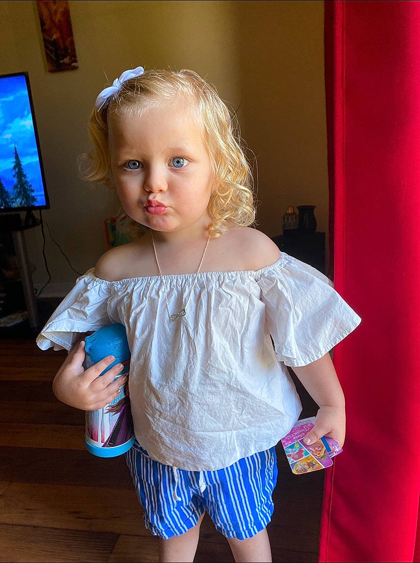 Ryleekay is registered to the contest to win money with this photo: arm, baby, blond, blue, child, dress, eye, hand, head, iris, joint, person, pink, play, shoulder, skin, smile, standing, textile, toddler