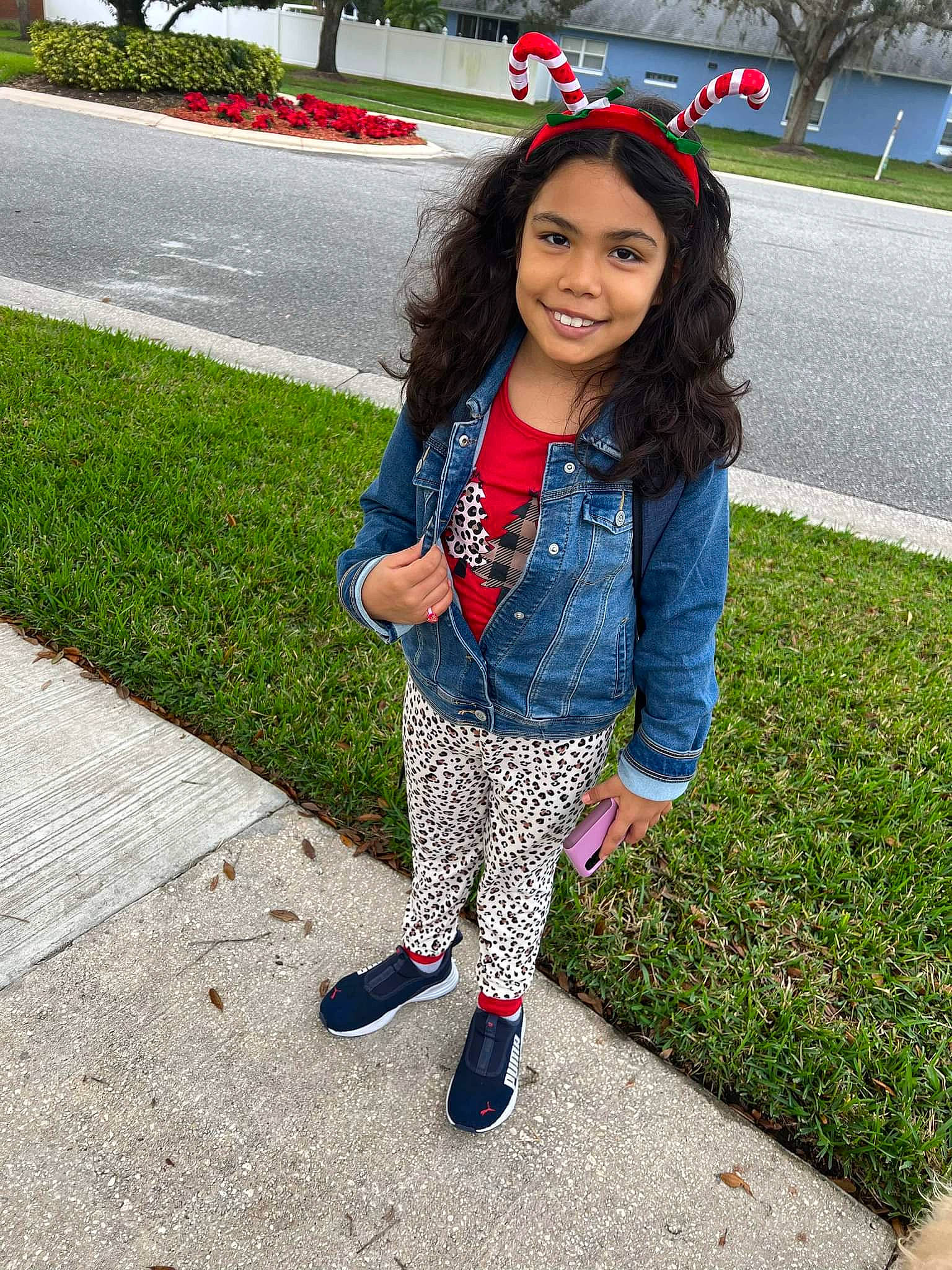 Marcella is registered to the contest to win money with this photo: asphalt, bangs, denim, electric_blue, grass, happy, human_leg, joy, leisure, magenta, pattern, person, plaid, plant, recreation, sidewalk, sleeve, smile, t_shirt, thigh