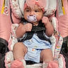 Carla is registered to the contest to win money with this photo: baby, infant, car_seat, pacifier, pink_bow, headband, clothing, socks, child, seatbelt, cute, portrait, indoor, baby_girl, soft_toys, accessory, sitting, closeup, comfort, baby_gear