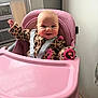 baby, high_chair, pink, smiling, indoor, child, leopard_print, clothing, seat_belt, window, wall, cheerful, cute, infant, person, happy, waving, furniture, face, head