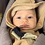 Lalo participe au concours pour gagner de l'argent avec cette photo : baby, infant, hoodie, pacifier, car_seat, child, face, clothing, close_up, seat, strapped, young, cute, indoors, portrait, expression, bundle, warm, soft, headwear