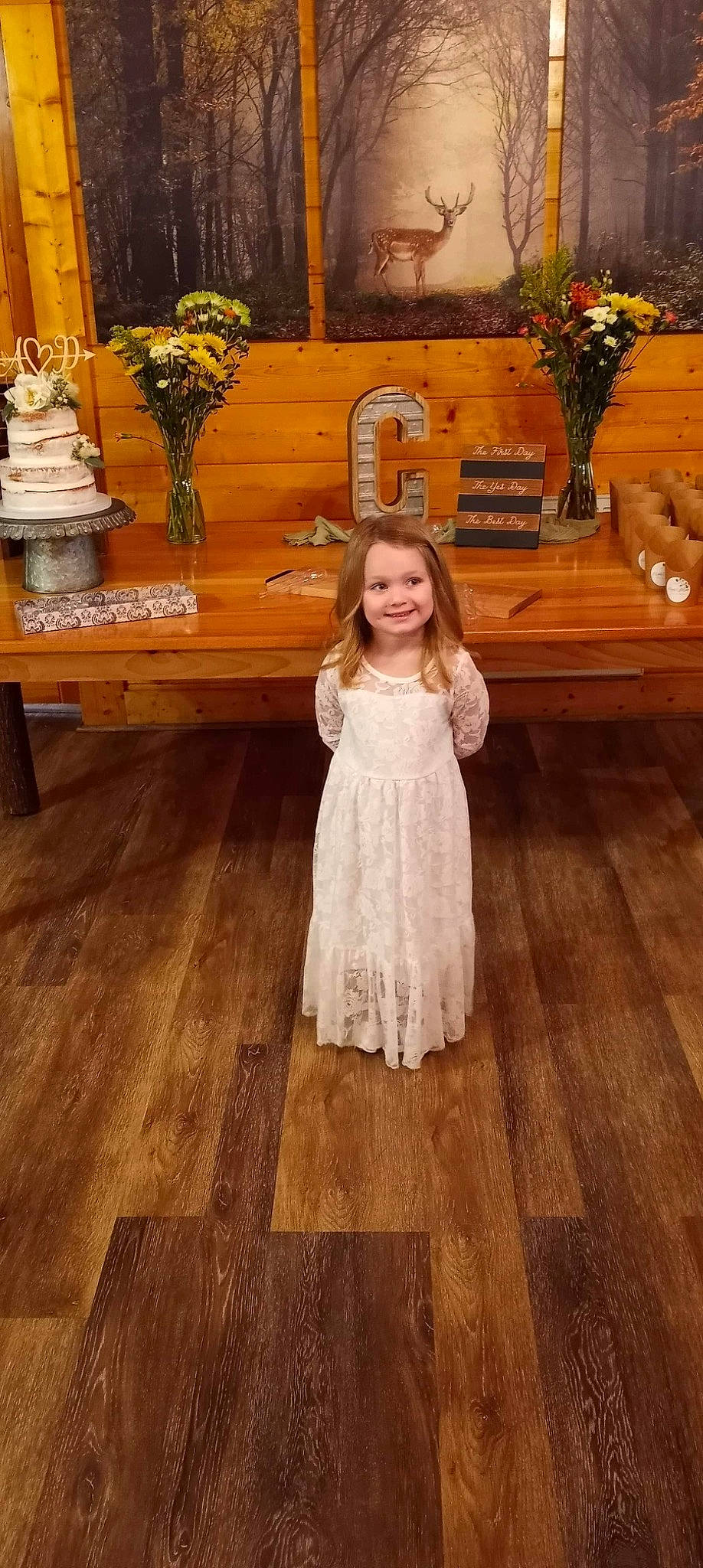 Maci is registered to the contest to win money with this photo: bench, dress, event, floor, flooring, flower, flower_arranging, flowerpot, formal_wear, happy, hardwood, joy, laminate_flooring, person, plant, smile, table, toddler, varnish, wood