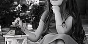 Kenza participe au concours pour gagner de l'argent avec cette photo : child, girl, lantern, long_hair, smile, sitting, dress, outdoor, daylight, portrait, face, hand, legs, concrete, happy, young, people, blurred_background, black_and_white, serene