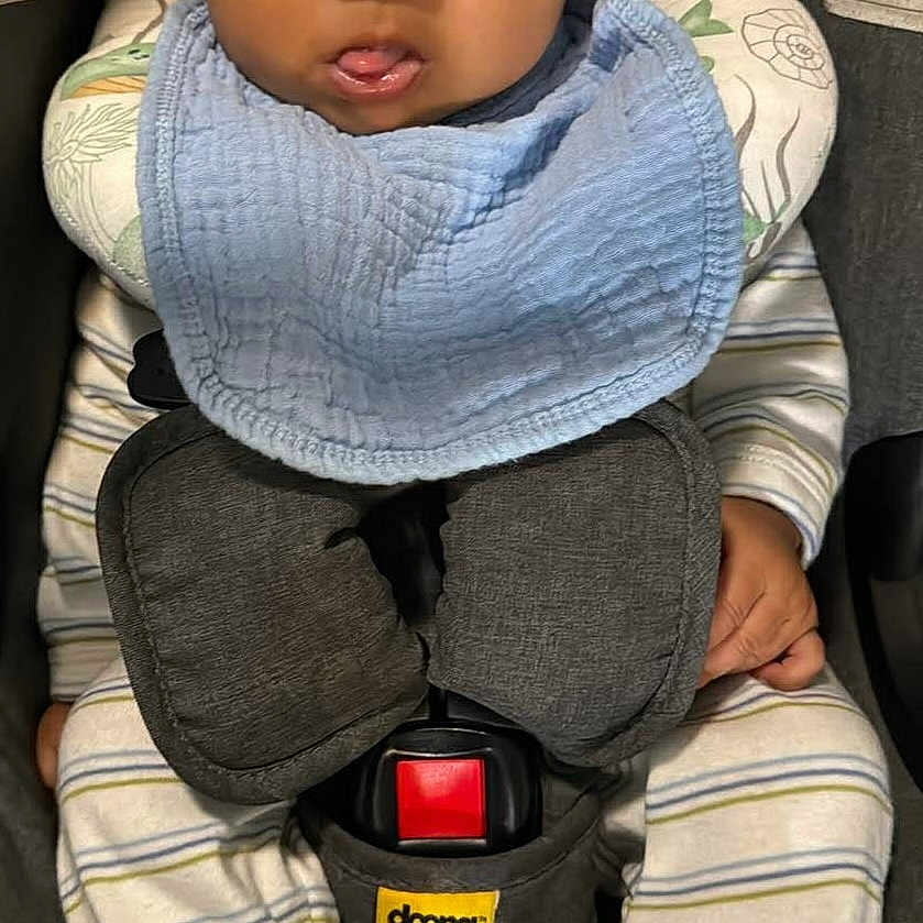 Austin Beirge joined the competition — help win amazing prizes! baby, infant, car_seat, blue_bib, striped_pajamas, child, seat_belt, safety, cute, tongue_out, indoors, clothing, person, face, head, eyes, hands, footwear, baby_gear, comfort