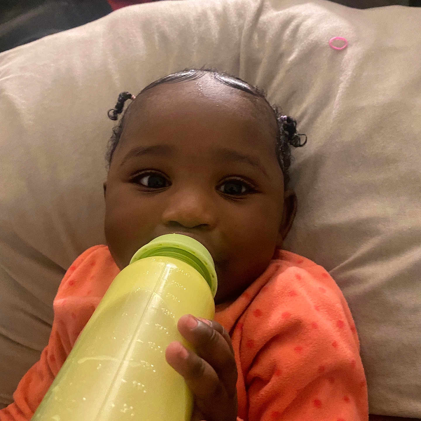 Naarai is registered to the contest to win money with this photo: baby, babylaughing, beverage, biting, bodypart, bottle, couch, cushion, drinking, face, finger, furniture, hand, head, homedecor, juice, person, photography, portrait, shaker