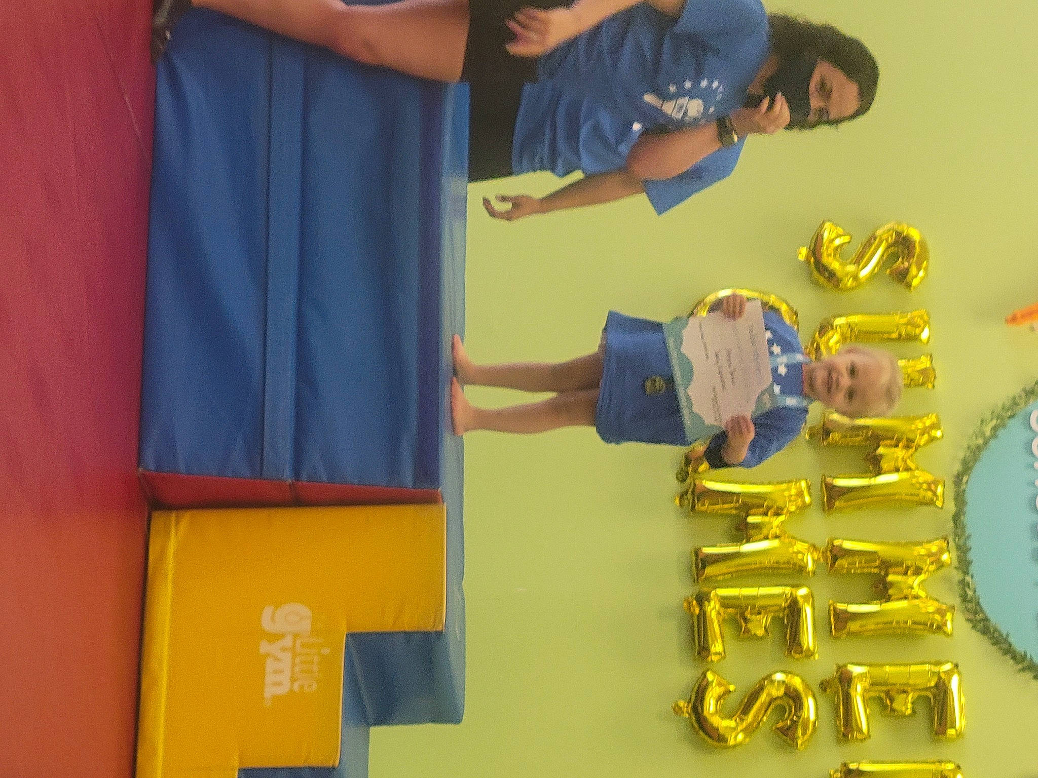 Athena is registered to the contest to win money with this photo: circle, elbow, electric_blue, event, fun, gesture, joy, leisure, metal, person, plastic, recreation, room, t_shirt, wrist, yellow