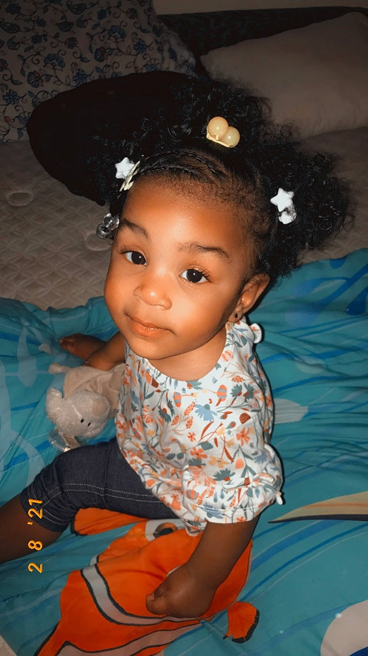 Belle is registered to the contest to win money with this photo: baby_toddler_clothing, black_hair, cheek, child, chin, cool, fashion_accessory, fashion_design, flash_photography, forehead, fun, hair_accessory, happy, headpiece, iris, jewellery, person, portrait_photography, sitting, skin