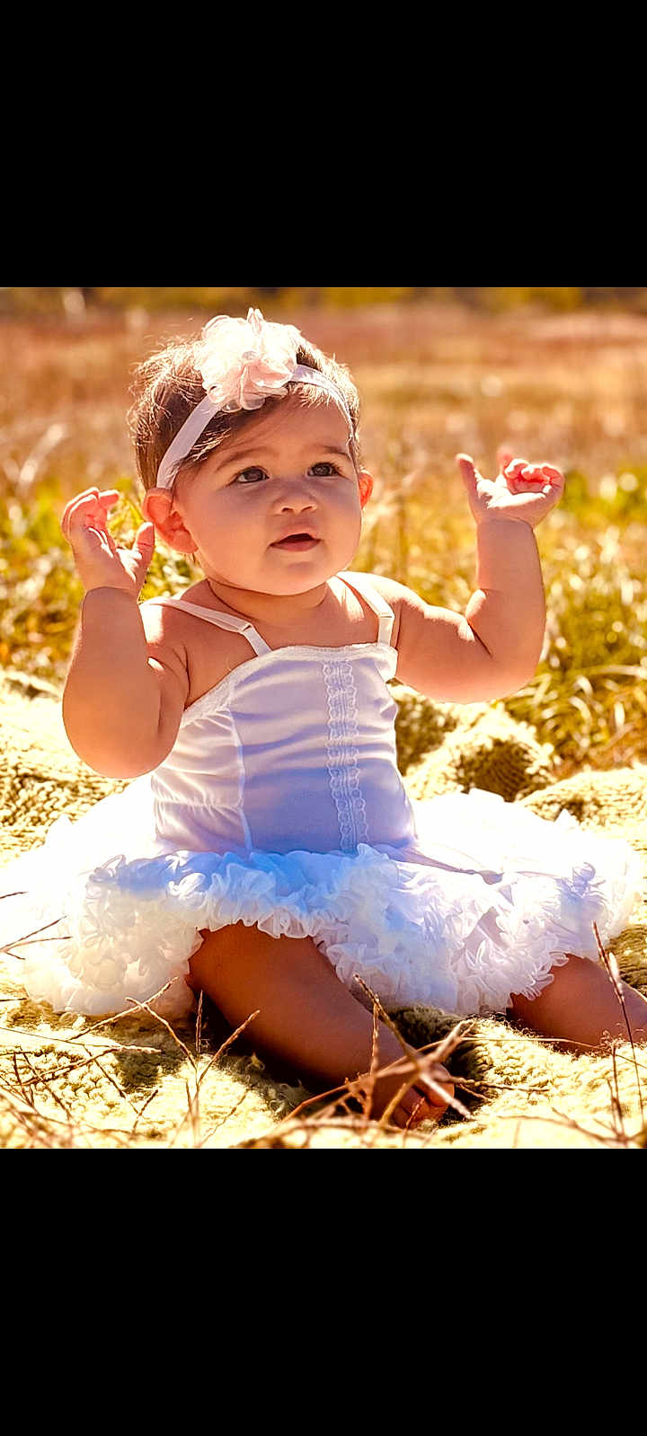 Lisa is registered to the contest to win money with this photo: baby, child, white_dress, headband, outdoor, grass, blanket, sunlight, cute, portrait, sitting, happy, infant, nature, summer, smile, young_child, one_person, young_baby, beauty