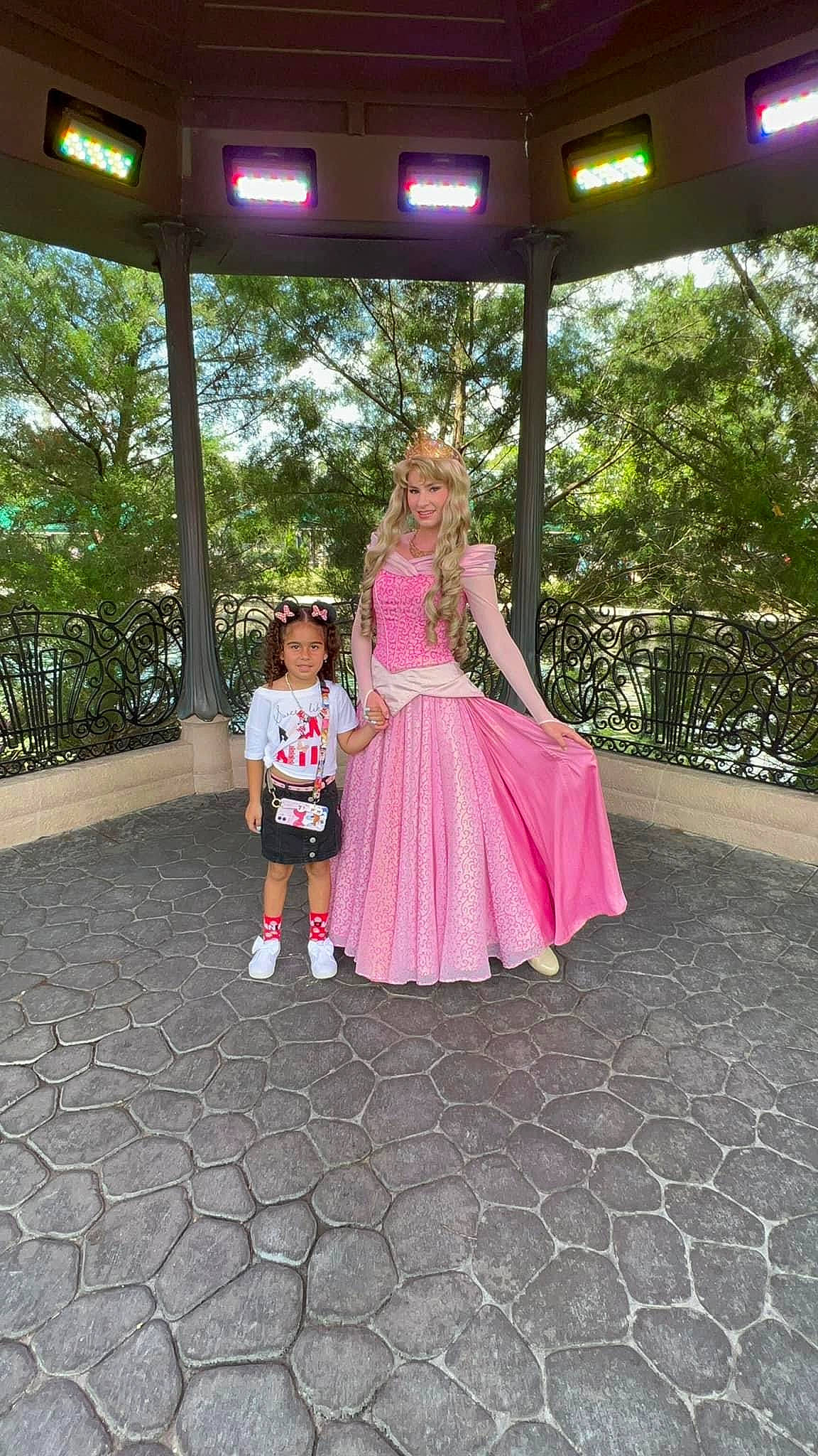 Melissa is registered to the contest to win money with this photo: boot, child, costume, dress, event, flooring, formal_wear, fun, garden, grass, happy, joy, leisure, magenta, pattern, person, pink, plant, recreation, toddler