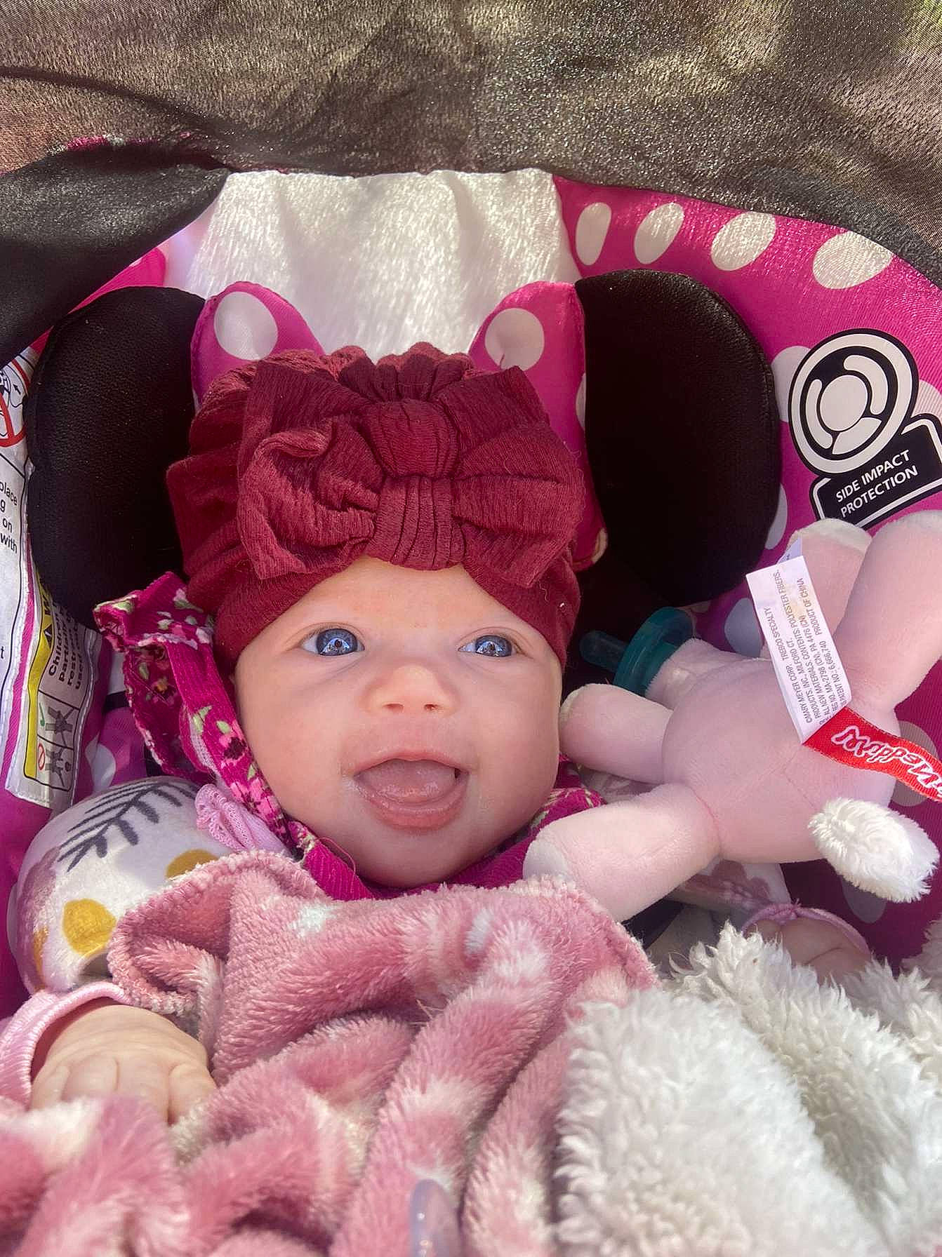 Isabella is registered to the contest to win money with this photo: baby, baby_products, baby_sleeping, baby_toddler_clothing, cap, cheek, comfort, face, headgear, headwear, knit_cap, linens, magenta, person, pink, product, skin, smile, toddler, white