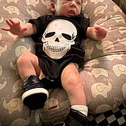 Jameson joined the competition — help win amazing prizes! baby, infant, onesie, skull_print, sneakers, cushion, elephant_pattern, soft_toy, clothing, footwear, person, indoor, cute, baby_boy, newborn, portrait, resting, small_feet, curious_expression, casual