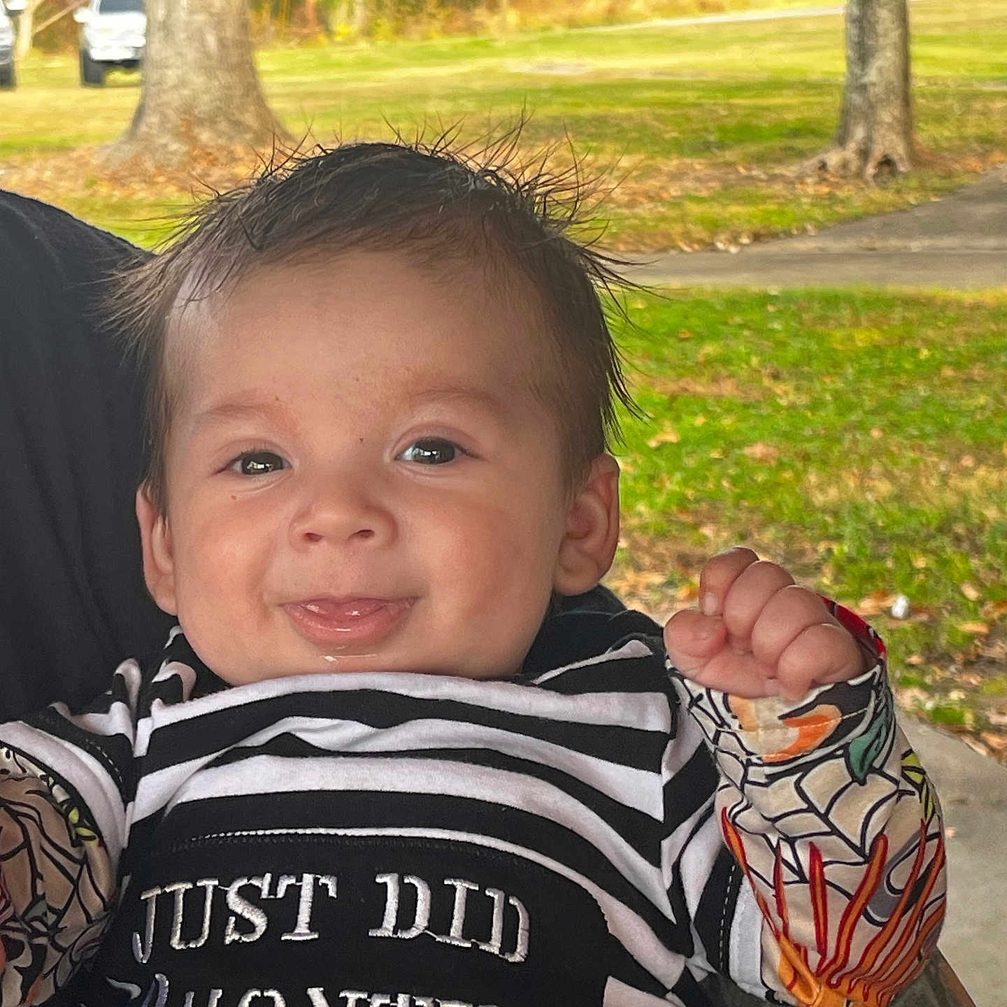 Jameson joined the competition — help win amazing prizes! baby, child, clothing, colorful_sleeves, cute, daylight, face, grass, happy, holding, infant, joyful, nature, outdoor, person, portrait, smiling, striped_shirt, tongue_out, tree