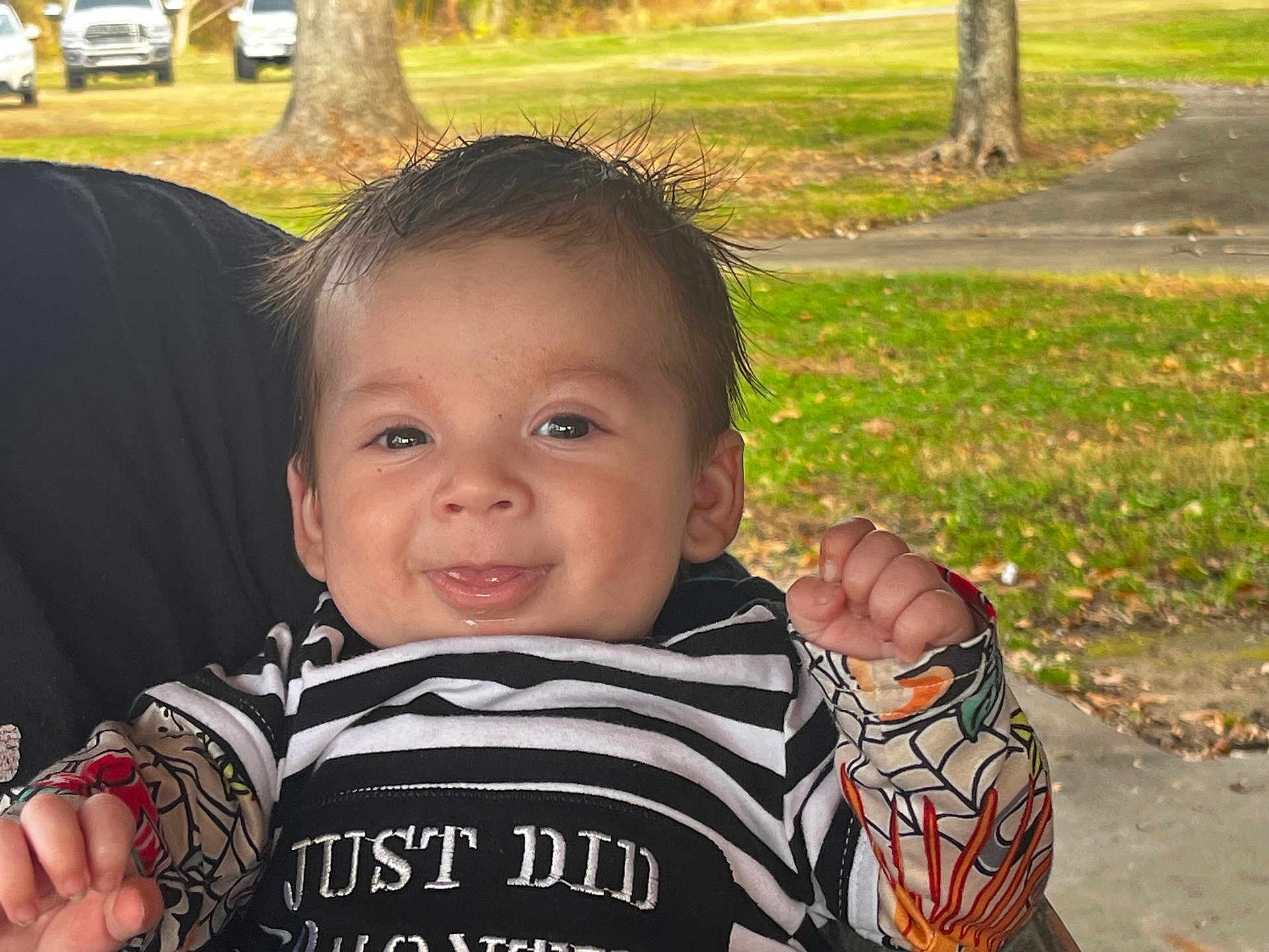 Jameson joined the competition — help win amazing prizes! baby, child, smiling, tongue_out, striped_shirt, colorful_sleeves, outdoor, grass, tree, person, happy, portrait, cute, infant, face, clothing, nature, daylight, holding, joyful
