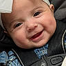 baby, infant, child, smiling, happy, portrait, face, close_up, bow, headband, car_seat, seatbelt, harness, blue_clothing, denim, vehicle, indoor, photography, adorable, 安全