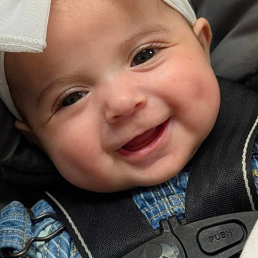 Xiah joined the competition — help win amazing prizes! baby, infant, child, smiling, happy, portrait, face, close_up, bow, headband, car_seat, seatbelt, harness, blue_clothing, denim, vehicle, indoor, photography, adorable, 安全