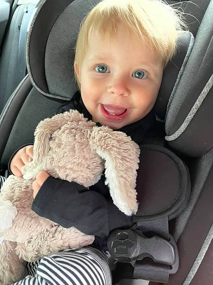 Josephine is registered to the contest to win money with this photo: auto_part, baby, baby_products, baby_toddler_clothing, blue, car_seat, car_seat_cover, comfort, gesture, happy, head_restraint, luxury_vehicle, mammal, person, personal_luxury_car, seat_belt, smile, steering_wheel, textile, toddler