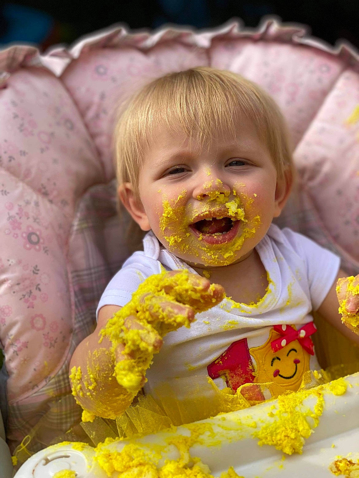 Josephine is registered to the contest to win money with this photo: baby, baby_toddler_clothing, dress, eye, face, fun, hairstyle, happy, head, iris, lei, lip, mouth, people_in_nature, person, plant, skin, smile, sweet_corn, toddler